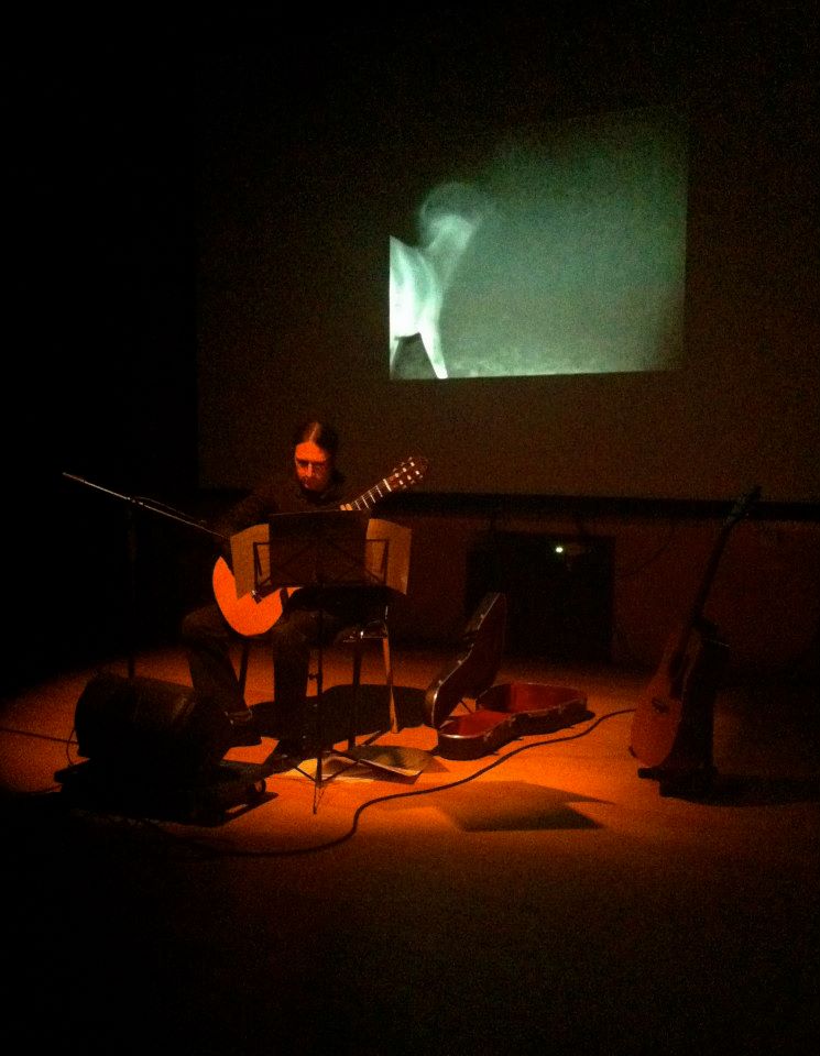 Musician Phillip Lawson performing in front of visuals by Eoin O'Dowd